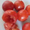 Z sześciu pomidorów ścinami czubki i za pomocą łyżeczki wydrążamy środki